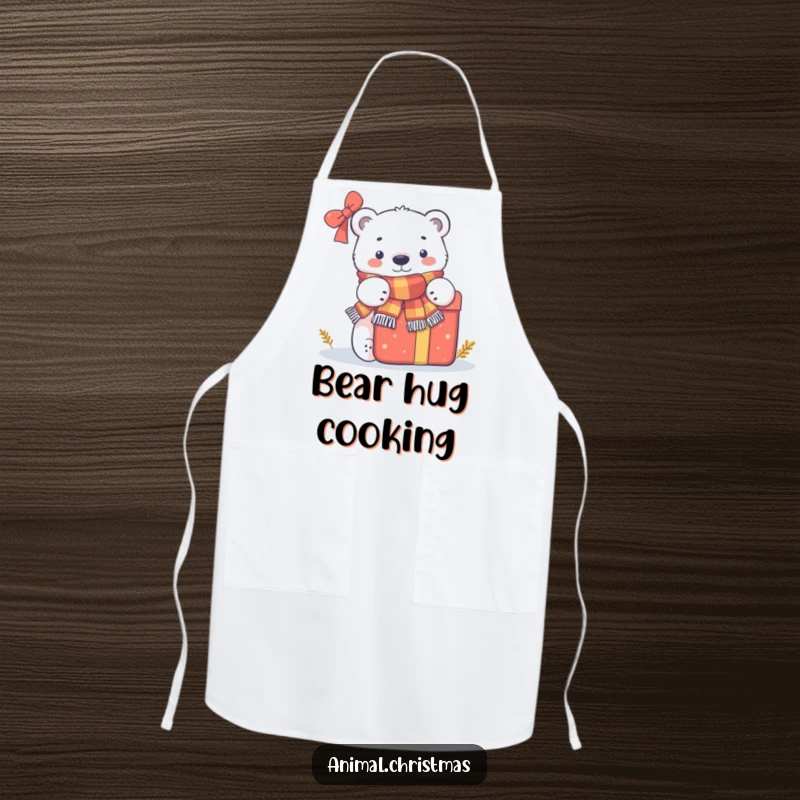 Funny apron showing a polar bear wearing a scarf and peeking behind a large gift, designed for festive winter cooking.