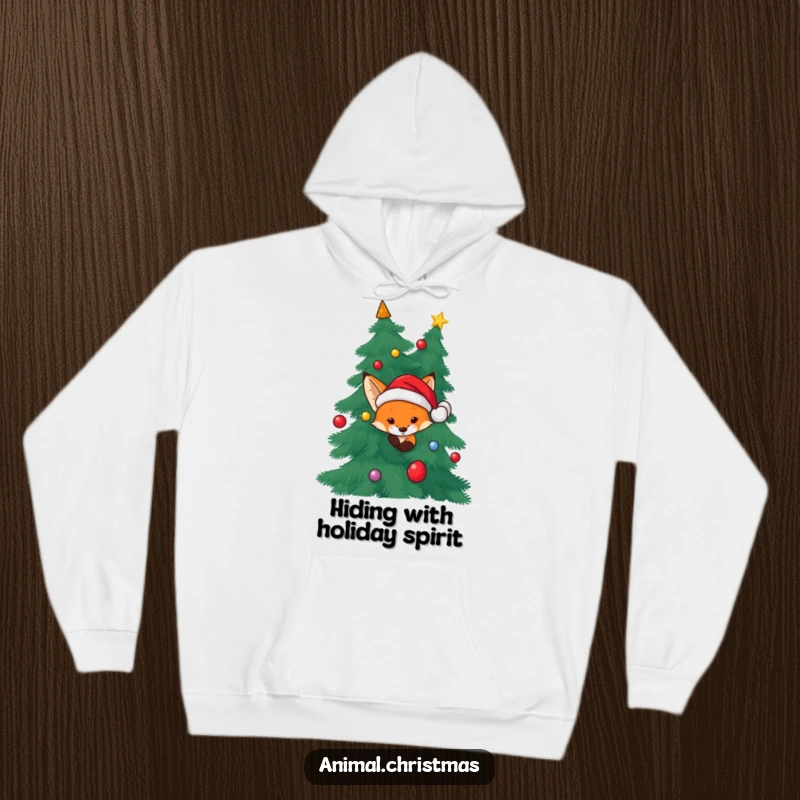 Funny Fox Santa Hoodie: A fox wearing a Santa hat peeking from behind a Christmas tree, ideal for cozy winter wear.