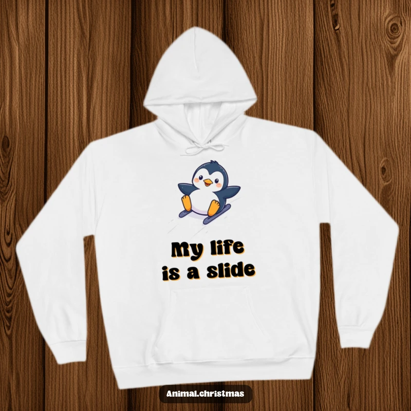 Funny kawaii penguin sliding down a snowy hill with glee, featured on a soft and warm hoodie.