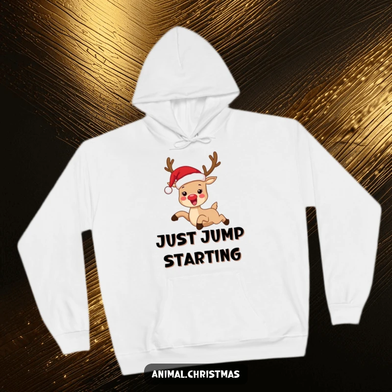 Funny hoodie depicting a reindeer in a Santa hat, joyfully leaping, making it a hilarious and cozy holiday apparel choice.