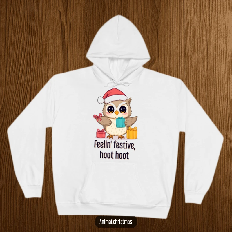 Funny hoodie showcasing a cute owl wearing a Santa hat, actively handing out gifts with a warm, festive vibe.