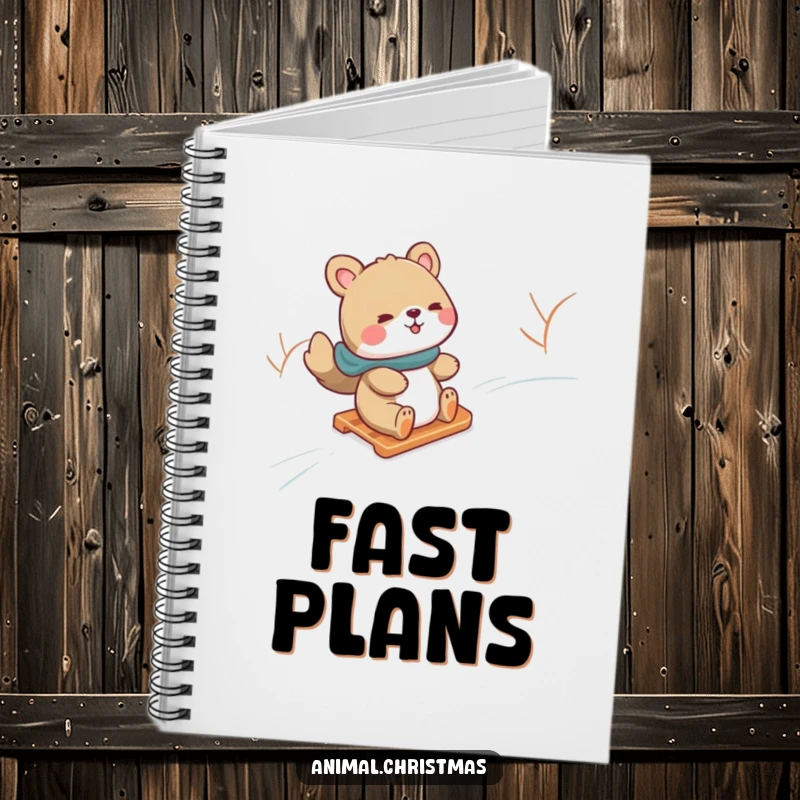 Funny notebook with an animal gleefully sliding down a snowy hill on a sled, ideal for jotting down winter adventures.