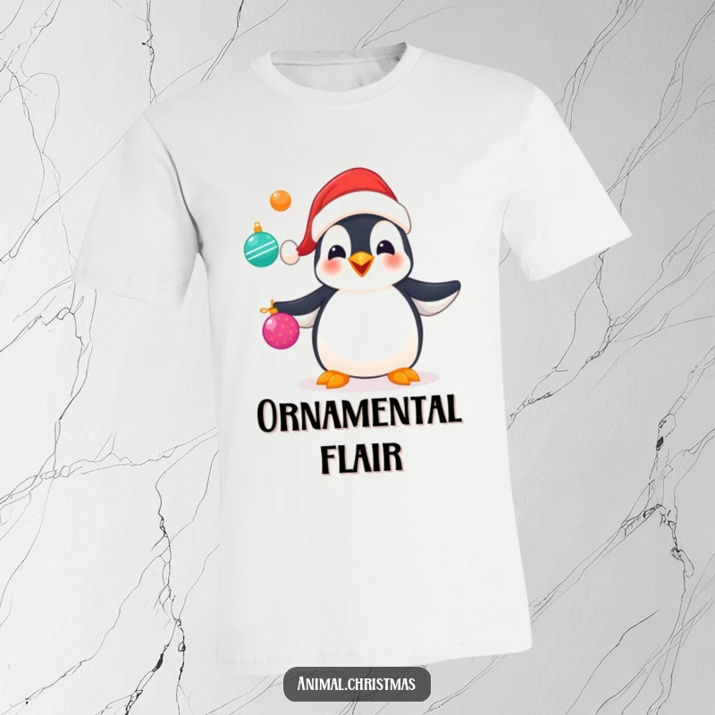 Funny t-shirt showing a penguin in a Santa hat gleefully juggling shiny Christmas ornaments with skill and joy.