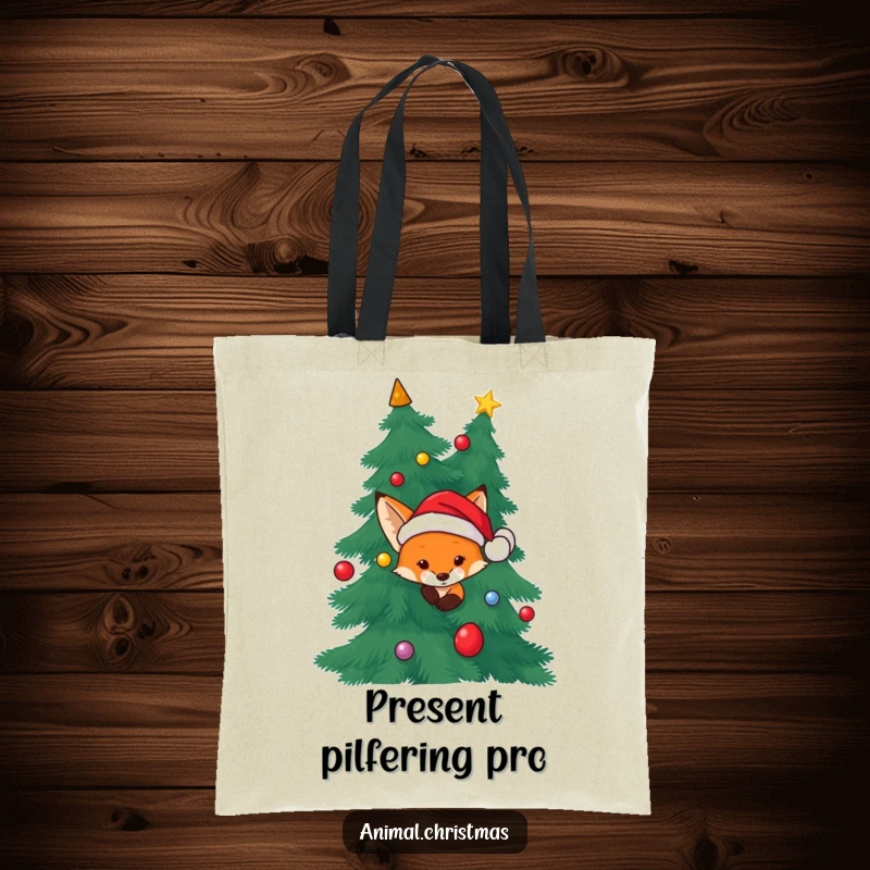Funny Fox Santa Tote Bag: A fox wearing a Santa hat peeking from behind a Christmas tree, great for everyday use.